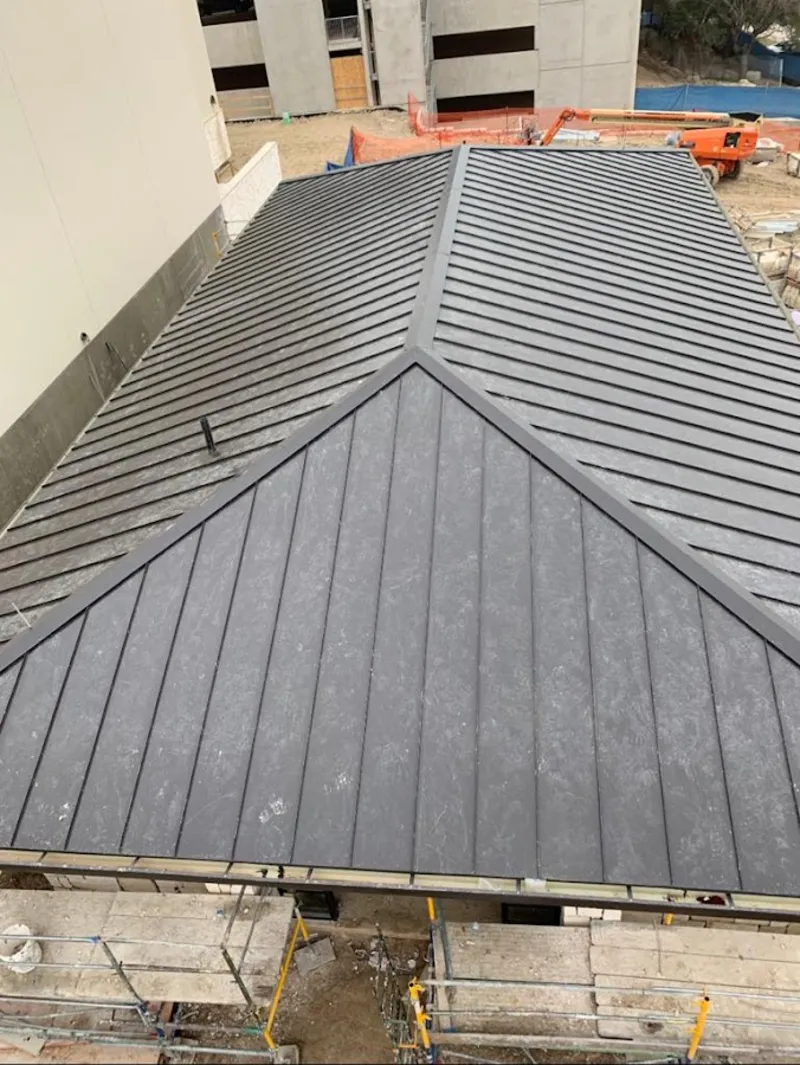Commercial metal roof construction with crane equipment in Republic
