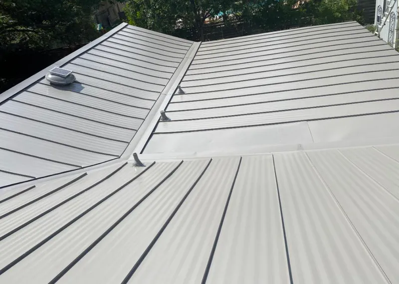 Solar attic fan installed on a metal roof for Roof Ventilation in Republic